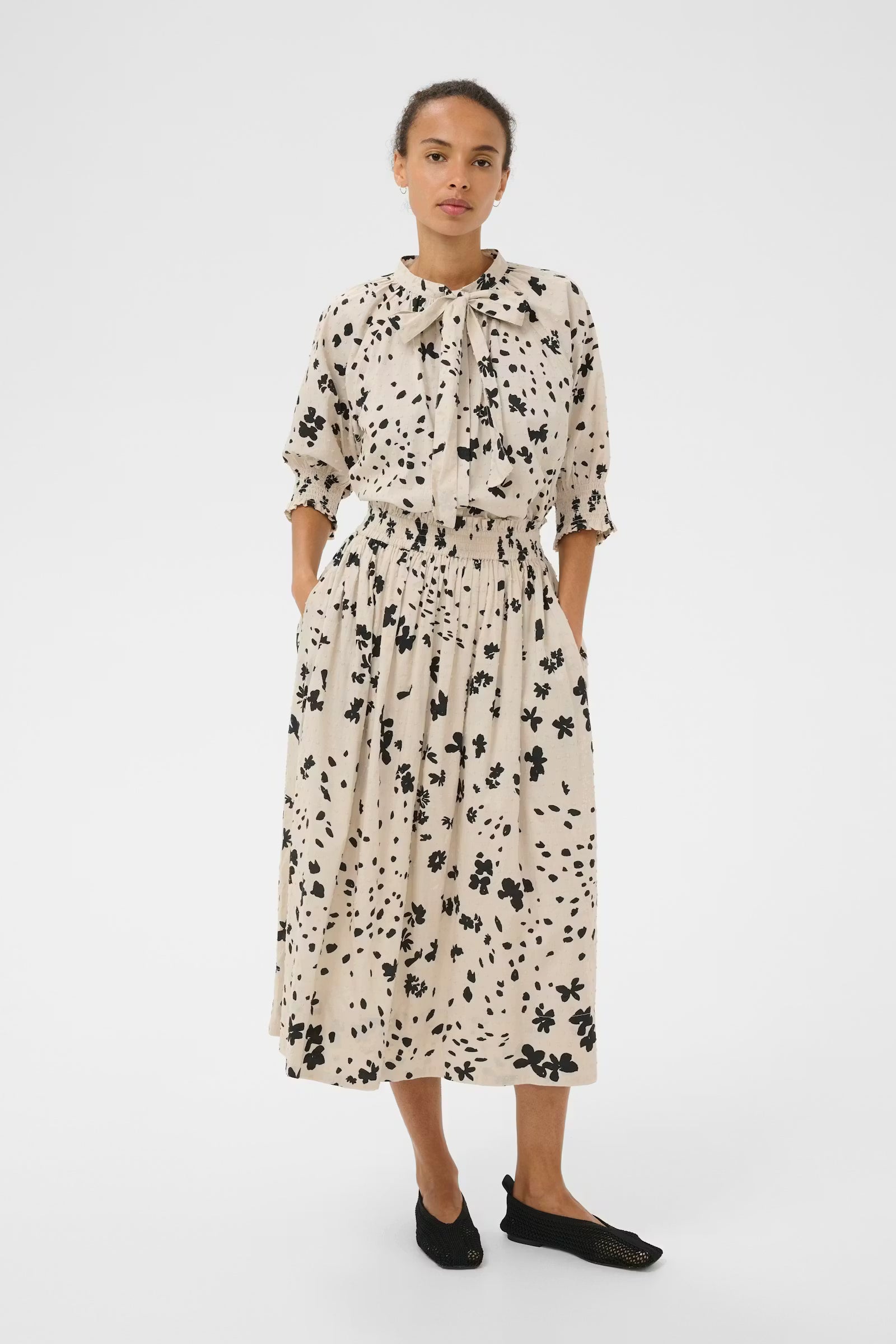 Woman wearing a floral dress on a white background