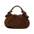 A dark brown suede slouchy handbag with knotted leather handles, shown against a plain white background.