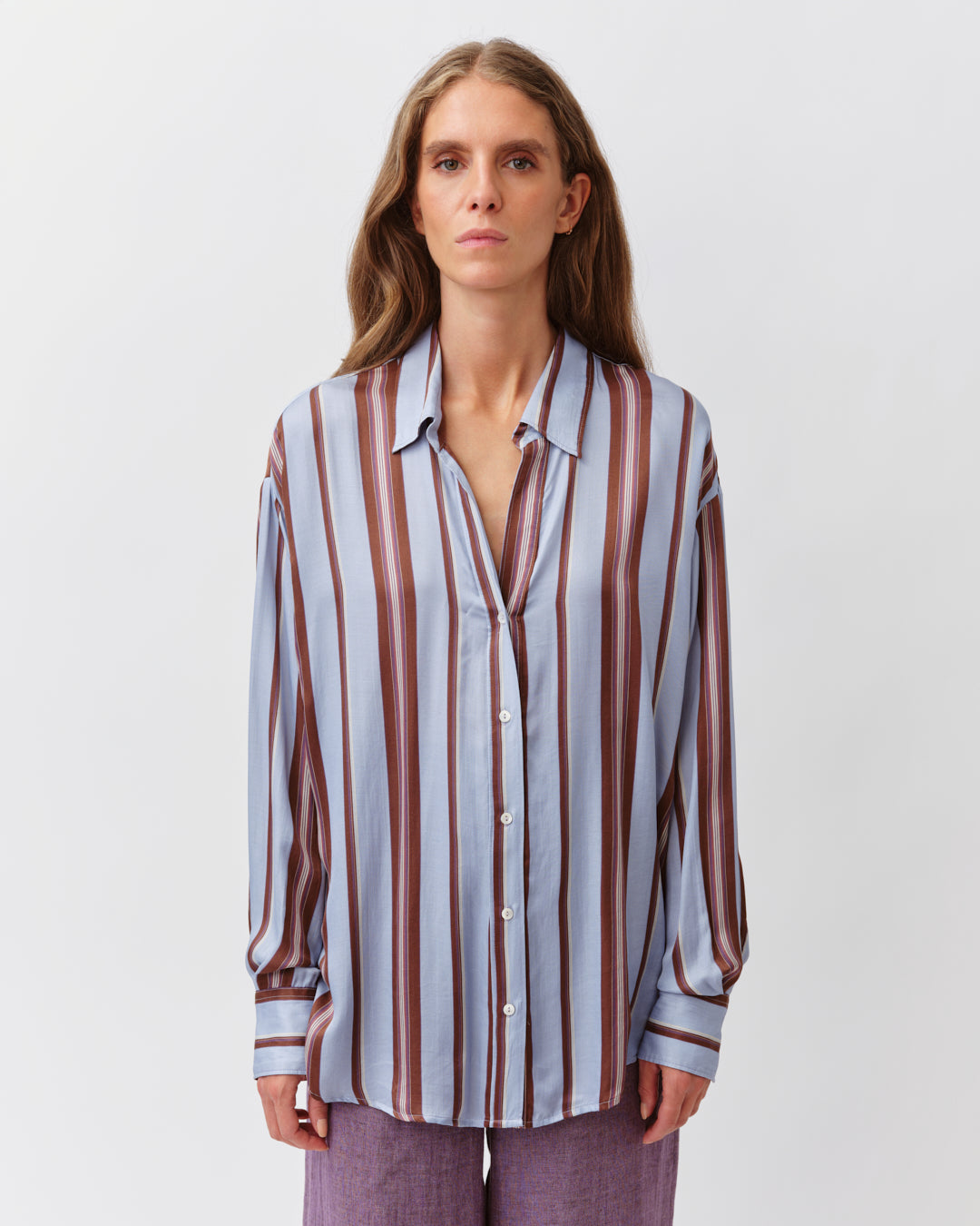 Woman wearing a striped shirt on a white background