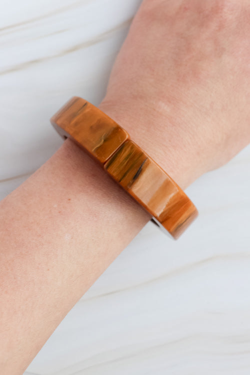 vintage Wooden bracelet on a wrist with a neutral background