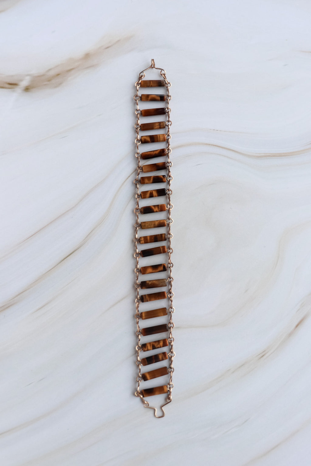 Long, thin bracelet with a zigzag pattern on a marble surface