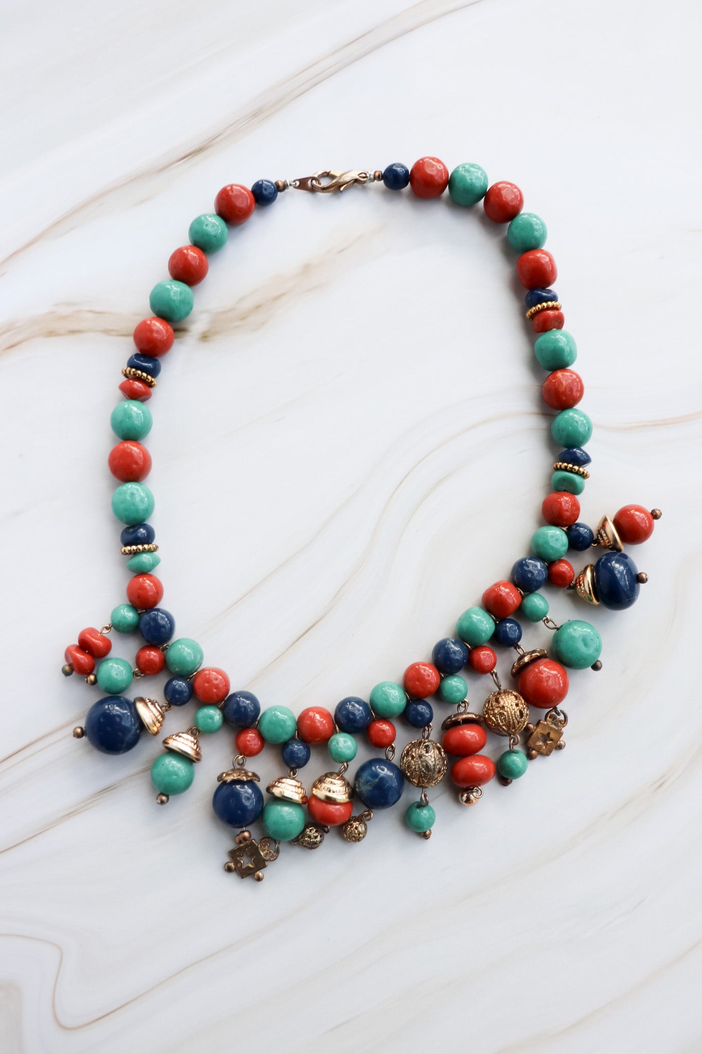 Colorful beaded necklace on a white marble surface