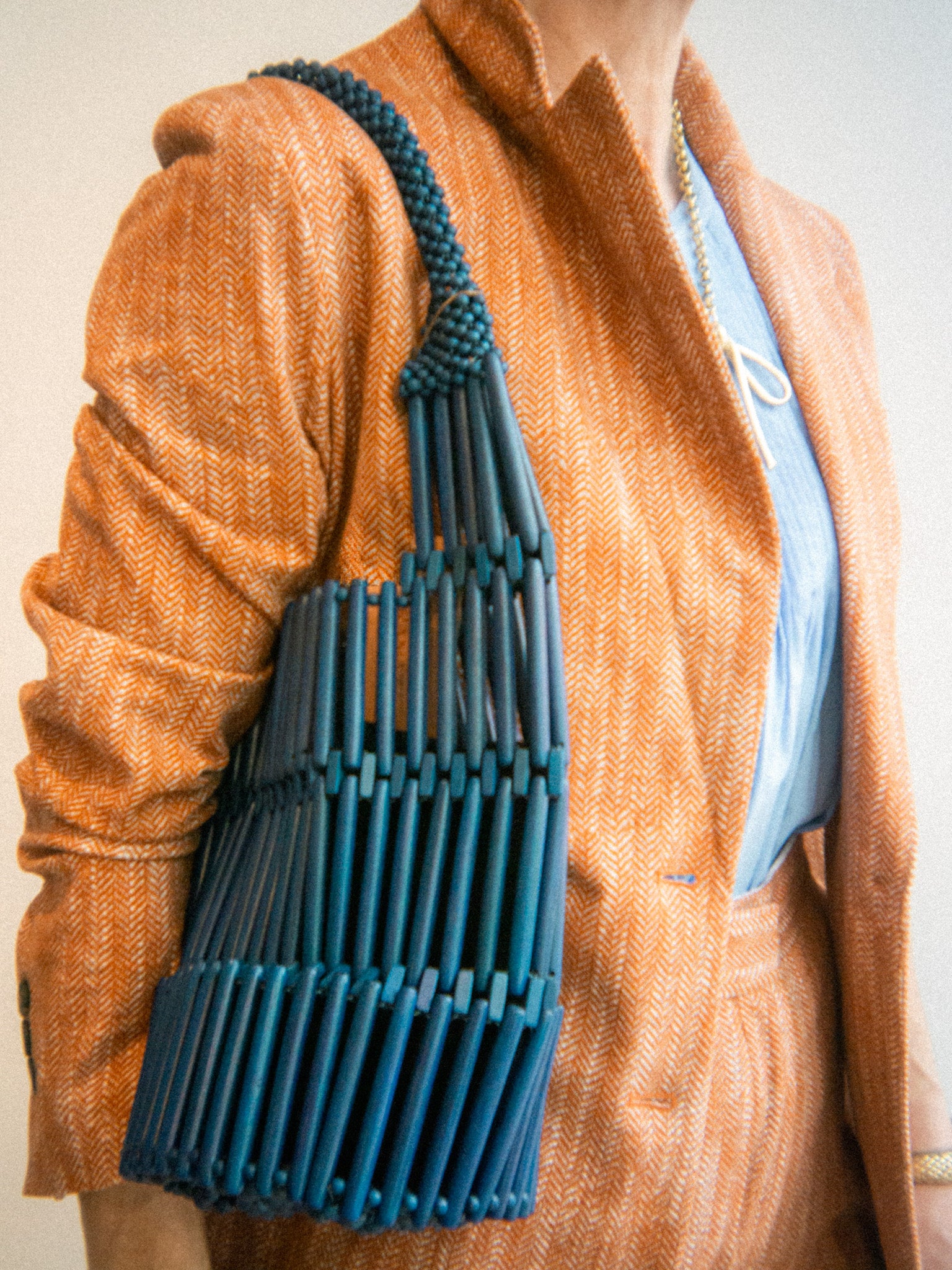 rust orange suiting matching set with cobalt blue beaded bag 