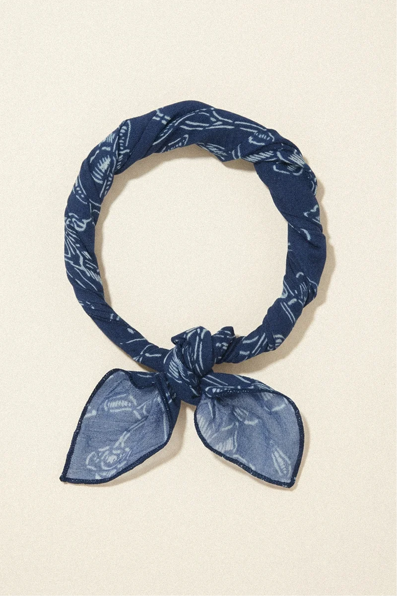 Blue patterned headscarf on a beige background