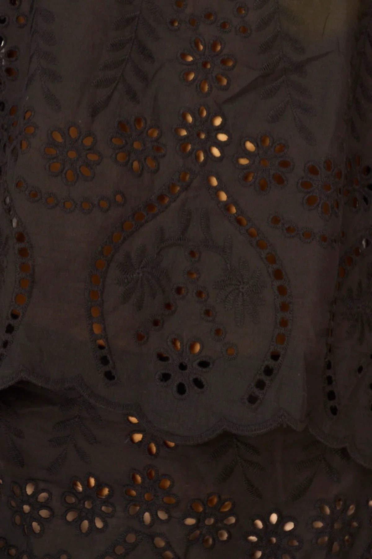 Close-up of a dark fabric with intricate gold embroidery
