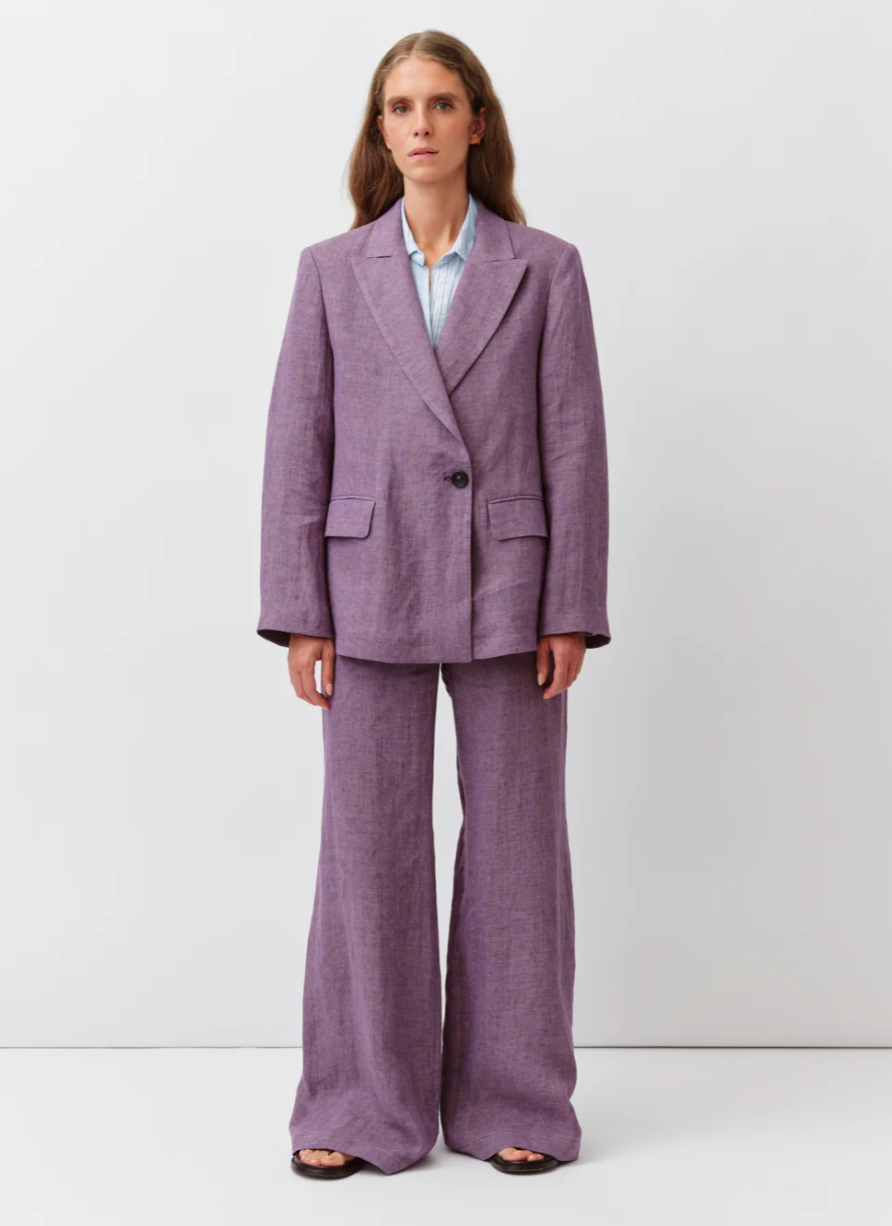Woman wearing a purple suit against a white background, cotton purple women's suit set, spring suiting, spring suit set, women's tailored suit set, dopamine dressing suit set, bright spring suit set 