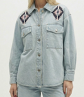 Light blue denim jacket with embroidered patterns on a plain background