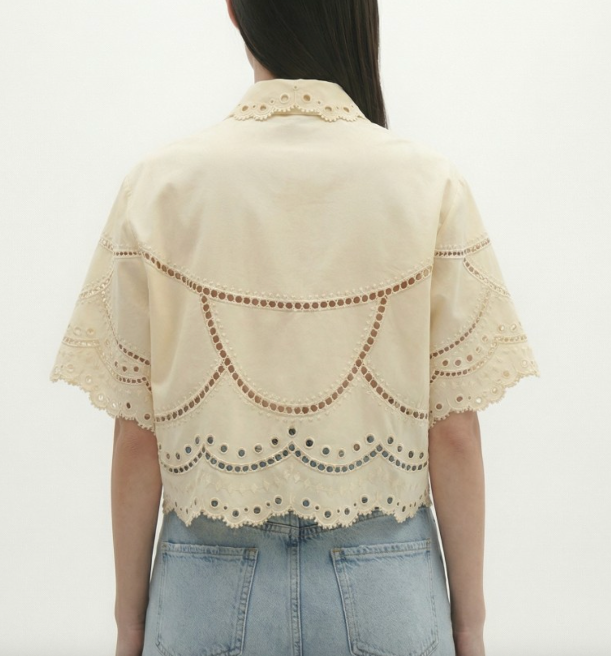 Beige lace shrug over a plain background