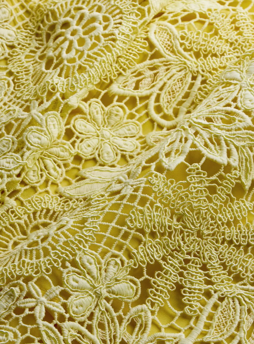 Close-up of gold lace fabric with floral patterns