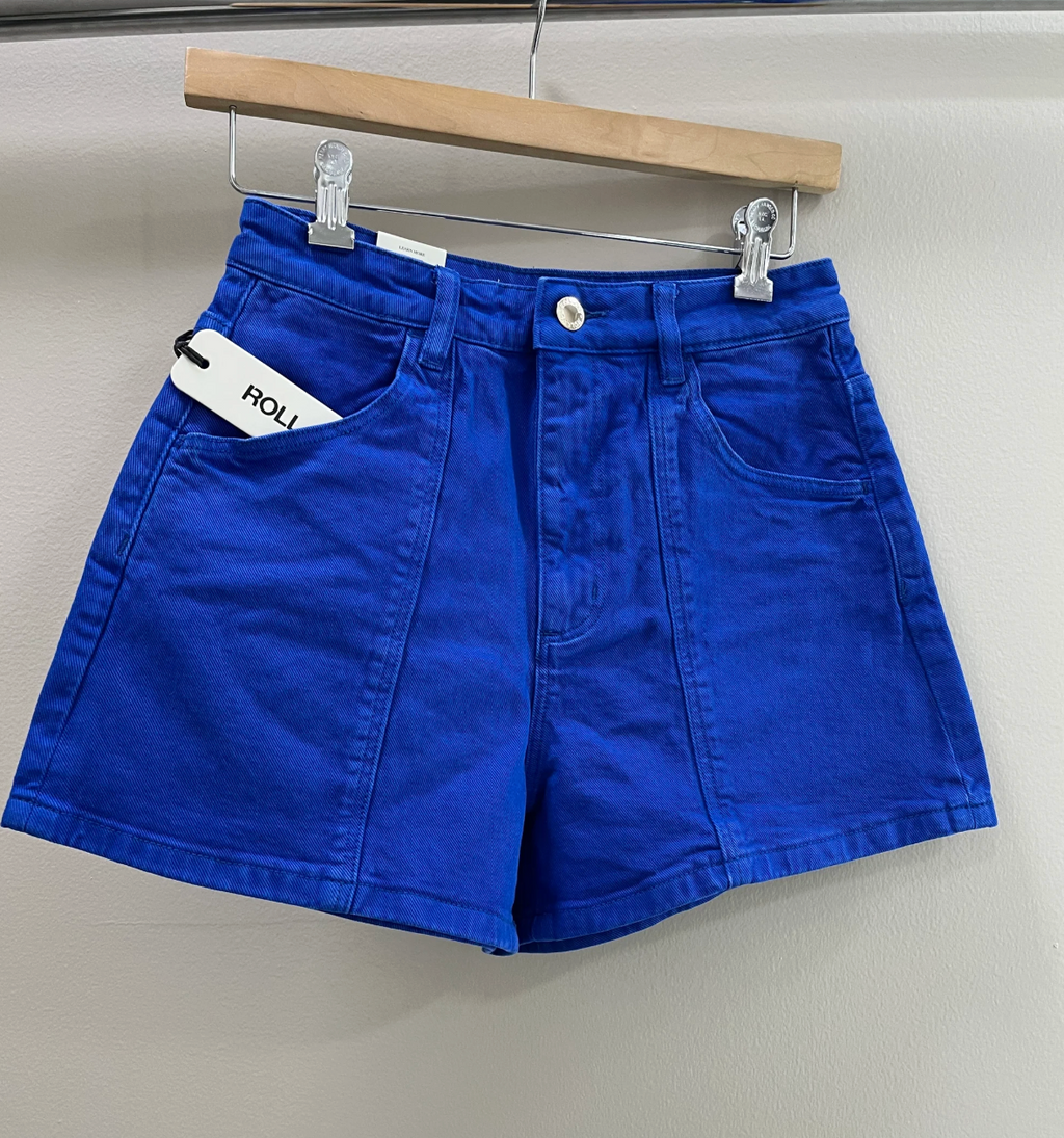 Blue shorts on a hanger against a plain background