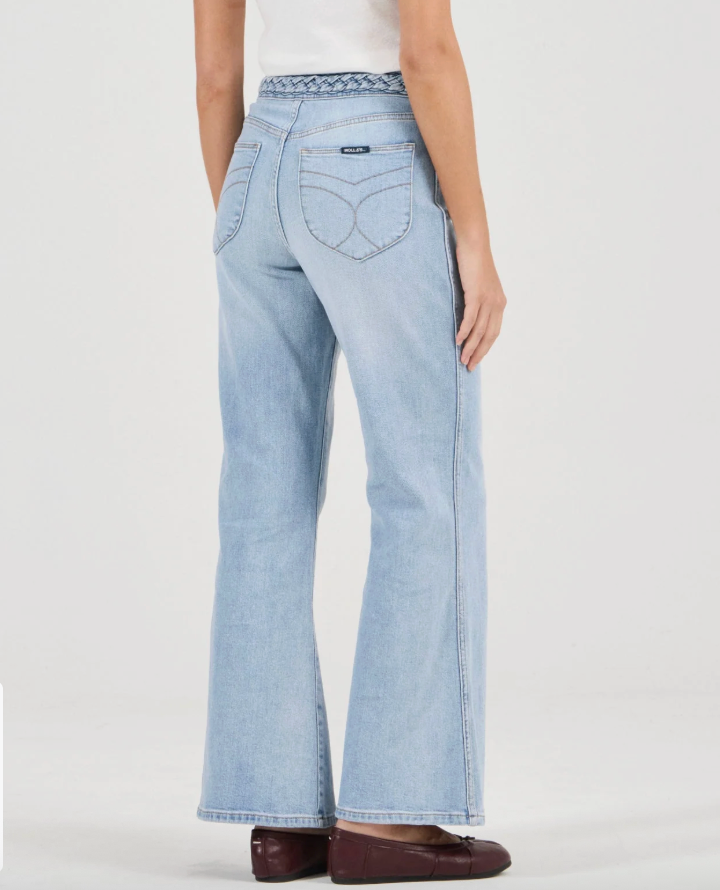 Light blue jeans worn by a person on a white background