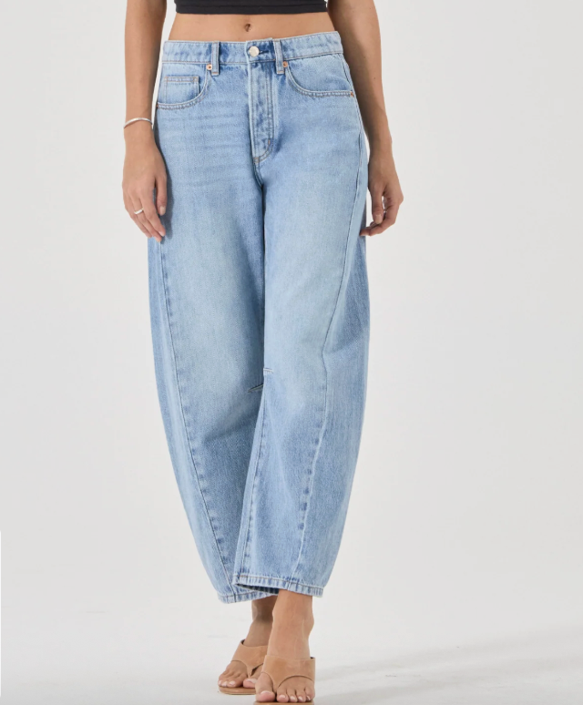 rollas Light blue jeans worn by a person on a white background