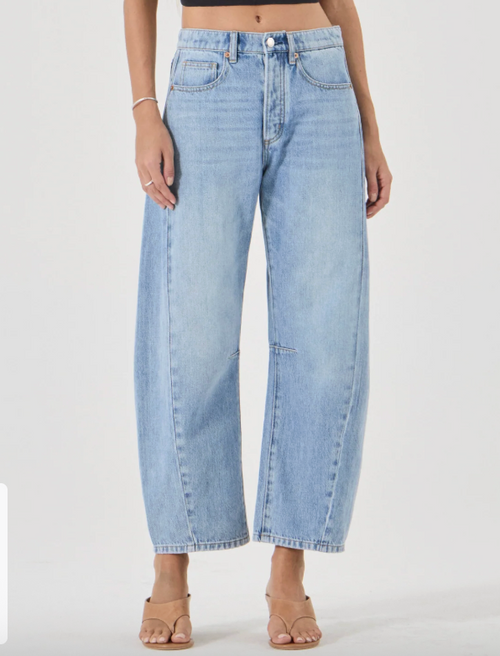 Light blue arc barrel jeans worn by a person on a white background