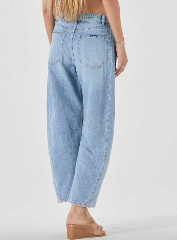 Light blue jeans worn by a person on a white background