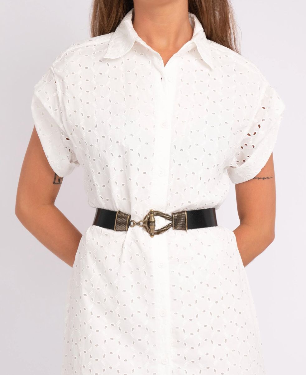 White dress with a black belt worn by a person on a white background