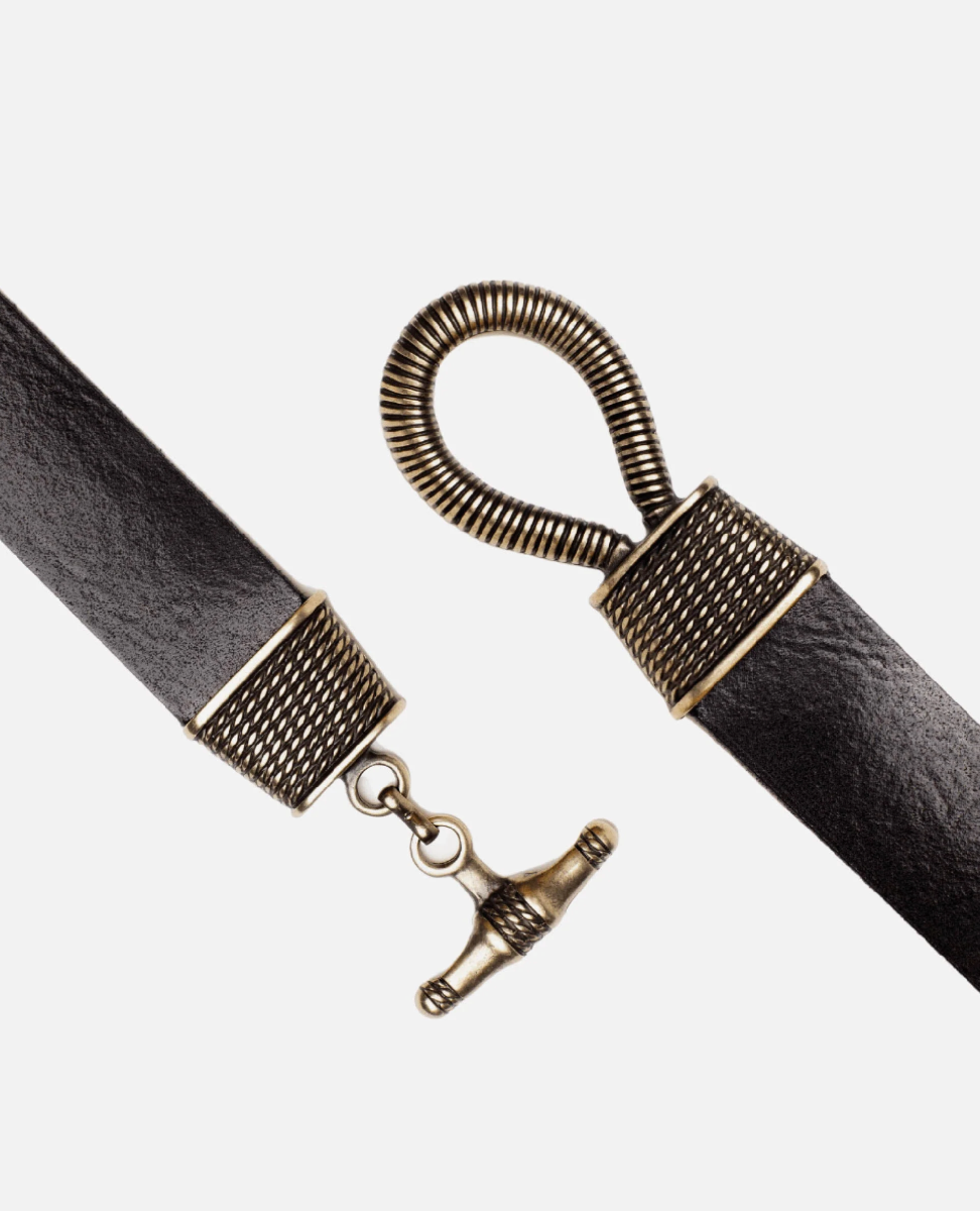 Close-up of a leather strap with a metal clasp on a white background