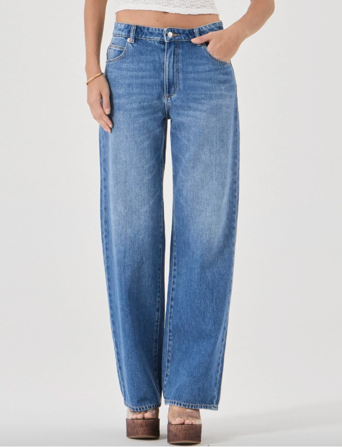 Person wearing blue jeans on a white background