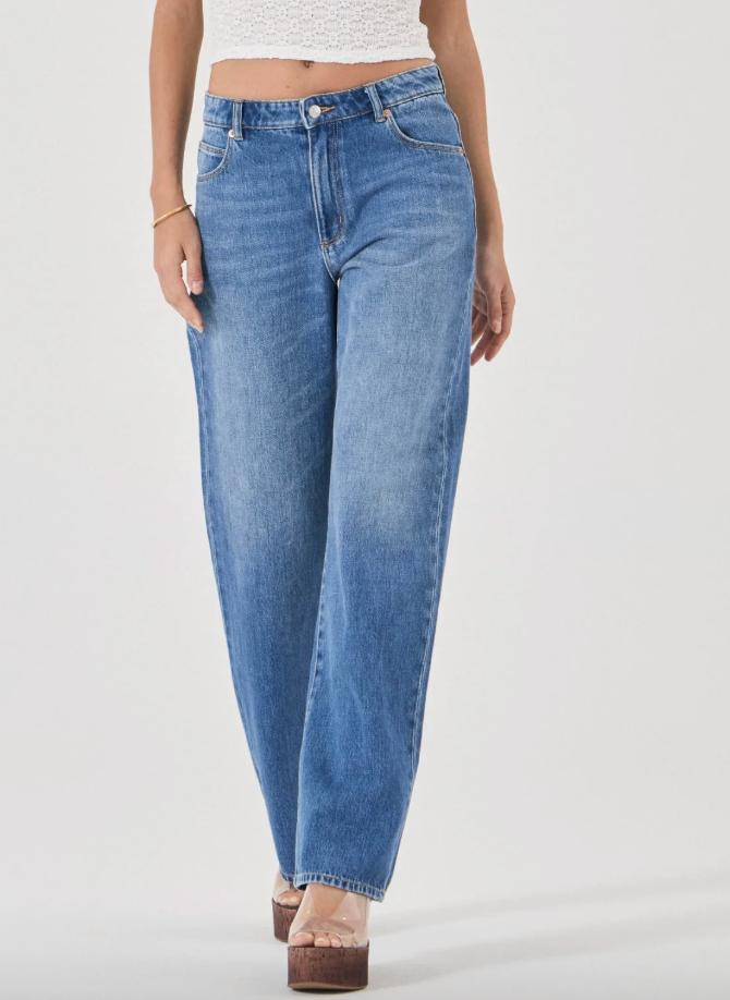 straight Blue jeans worn by a person on a white background