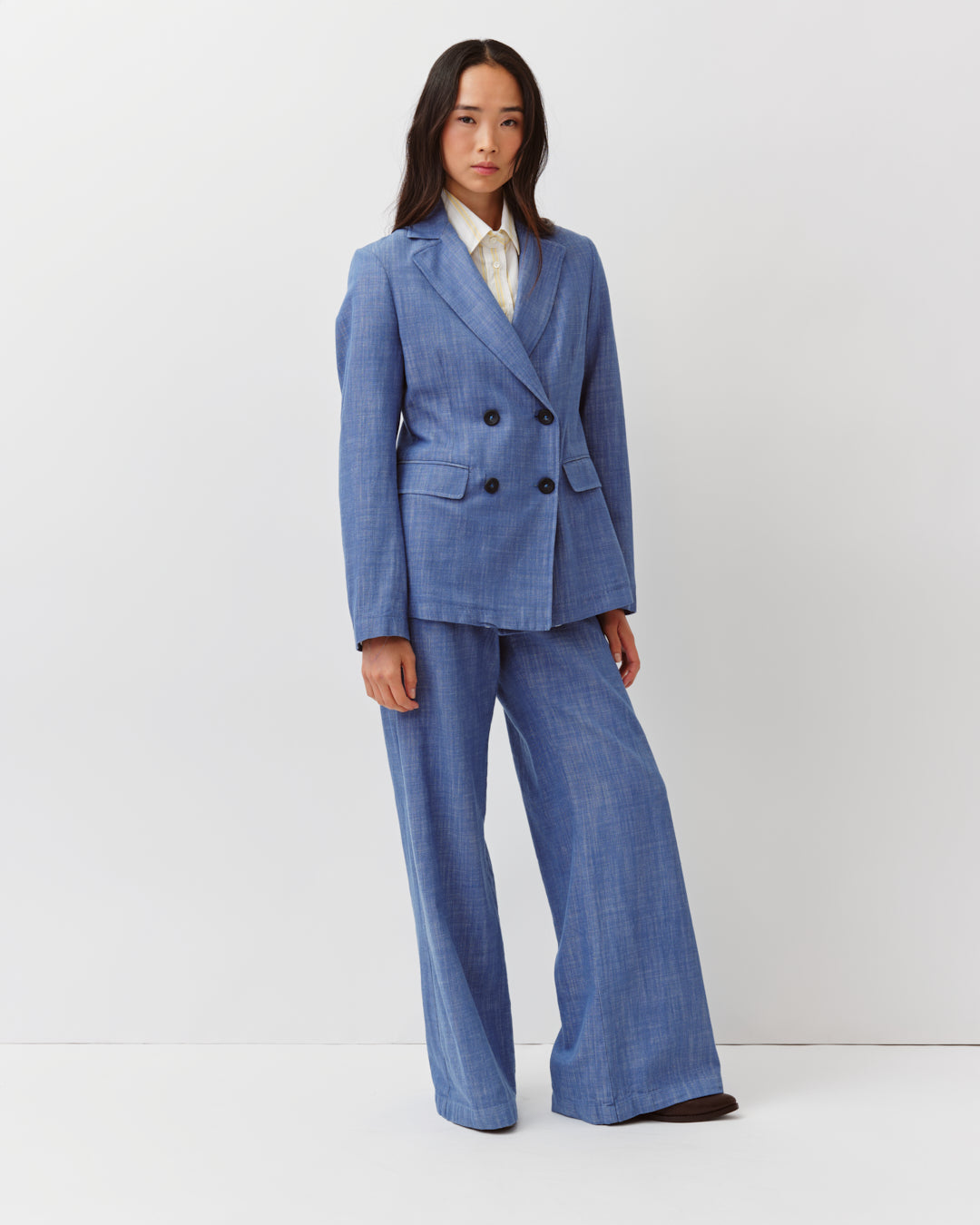 Woman wearing a blue suit on a white background