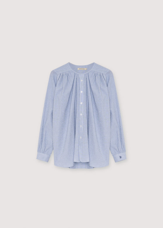 Light blue and white stripe blouse on a light gray background